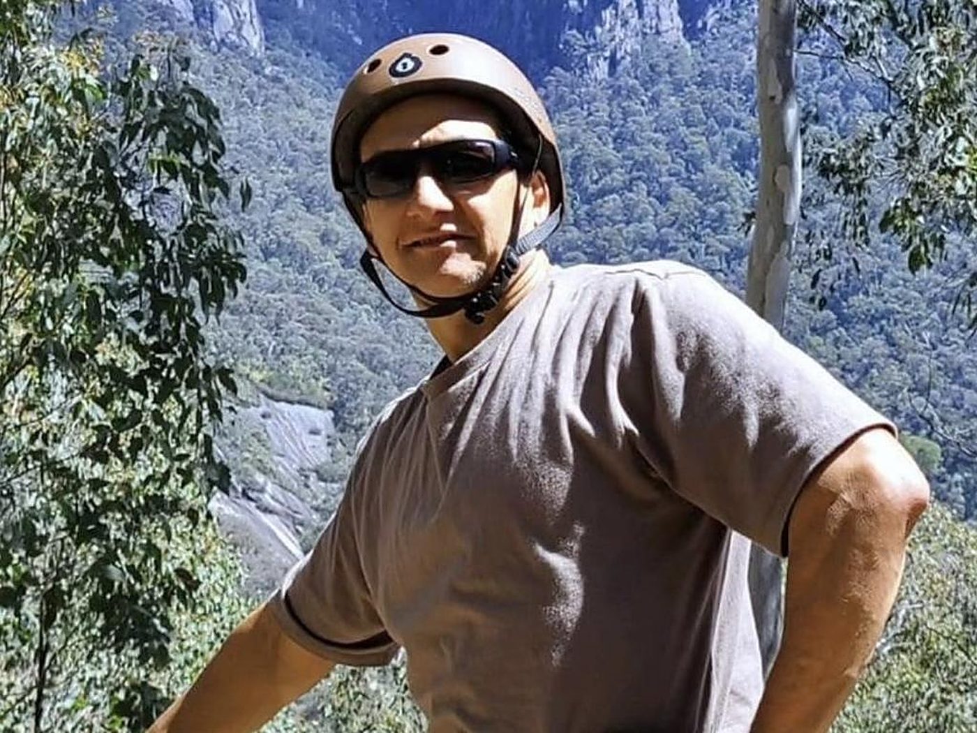 Freeman hiking the Mount Buffalo plateau with a rifle-shaped pack.