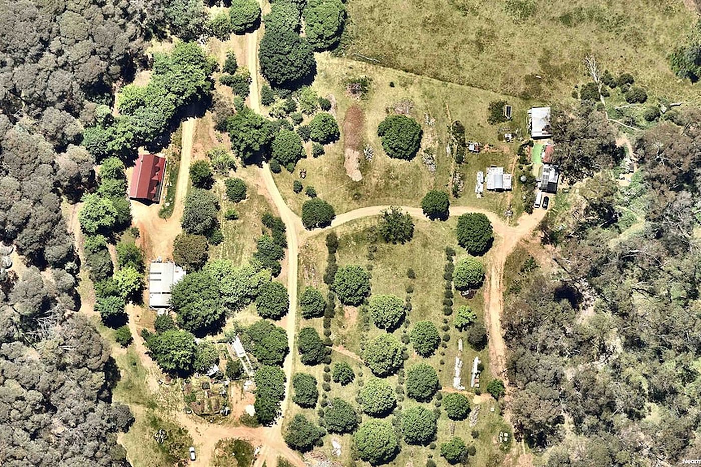 Aerial view of the farm at Porepunkah, tracks winding between sheds and gardens.