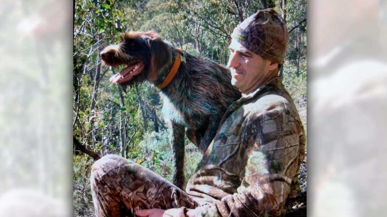 Neal Thompson in the bush with his hunting dog.